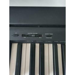 Yamaha elektrische piano met koptelefoon, bank en standaard